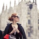 Shallow Focus Photography of Woman Holding Assorted-color Paper Bags